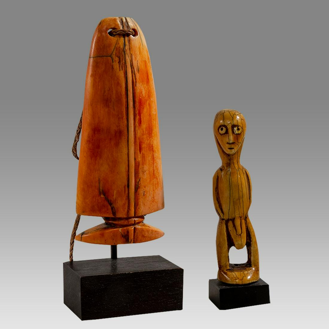 African, Carved Bone Erotic figure and Whale Tooth.: African, Carved Bone Erotic figure and Whale Tooth. Size 6 3/4 - 5 1/4 inchhigh. Carved bone nude male figure together with Whale Tooth? probably composition material? Custom mounted. Provenance:The E
