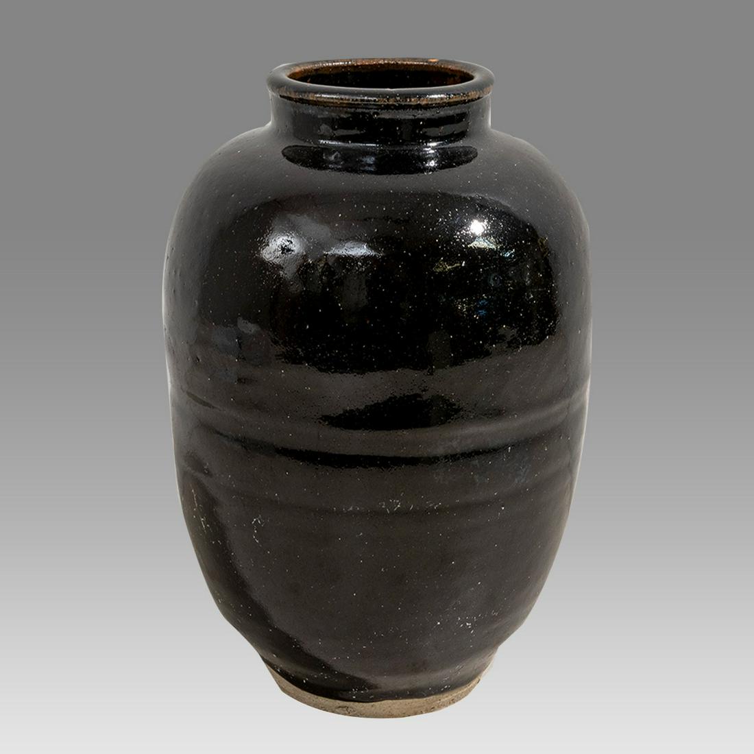 Antique Chinese Black Glazed Ceramic Wine Jar.: Antique Chinese Black Glazed Ceramic Wine Jar. Size 11 3/4 inches high. Great looking black cermaic wine jar. signed at base. Provenance:The Estate of Fred Pine NYC.