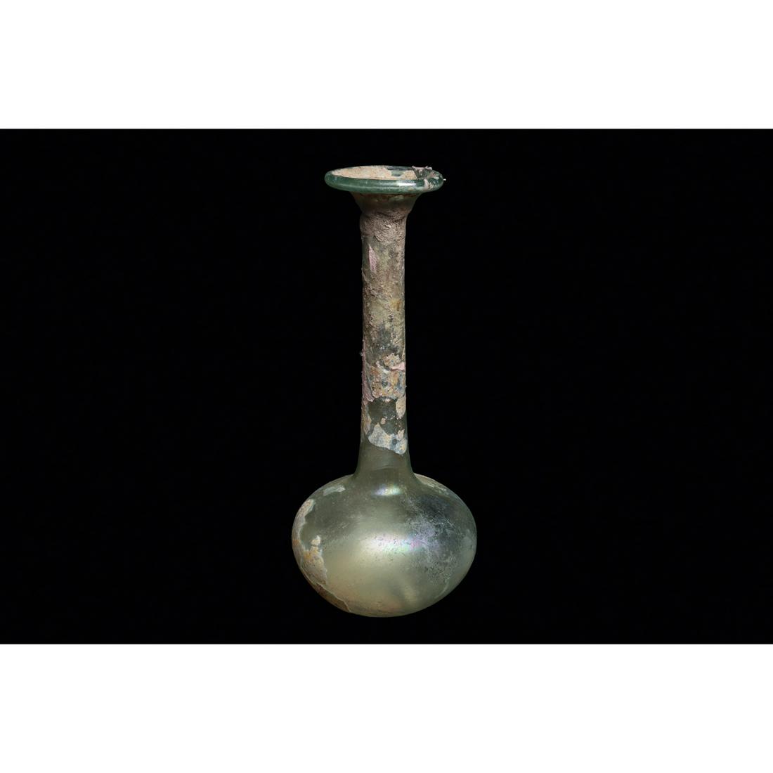Ancient Roman Light Green Glass Flask Ca. 1st-3rd century A.D.: Ancient Roman Light Green Glass Flask Ca. 1st-3rd century A.D. Size 6 5/8 inches high. Light blue-green blown glass bottle having a squat bulbous, and long cylindrical neck and flared lip. Scattered a