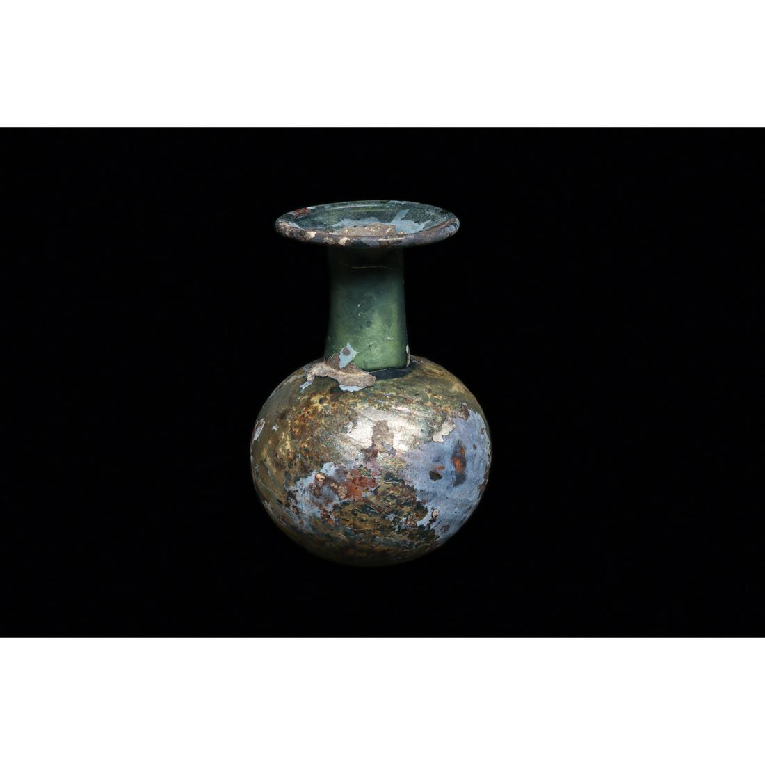 Ancient Roman Olive Green Glass Pattern Molded Bottle Ca. 1st-2nd century A.D.: Ancient Roman Olive Green Glass Pattern Molded Bottle Ca. 1st-2nd century A.D. Size 3 3/4 inches high. Yellow-olive blown glass bottle with a bulbous body, a spiral ribbed body design,, a cylindrical 