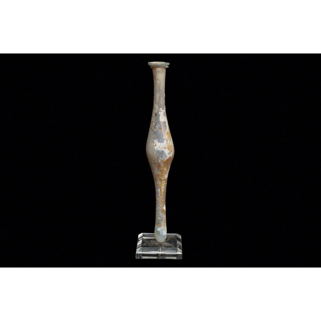 Ancient Roman Slender Glass Spindle Vial Ca. 2nd-3rd century A.D.: Ancient Roman Slender Glass Spindle Vial Ca. 2nd-3rd century A.D. Size 7 1/2 inches high + mount. Blown bluish-clear glass spindle type vial having a long double tapered body and rolled lip. Overall e