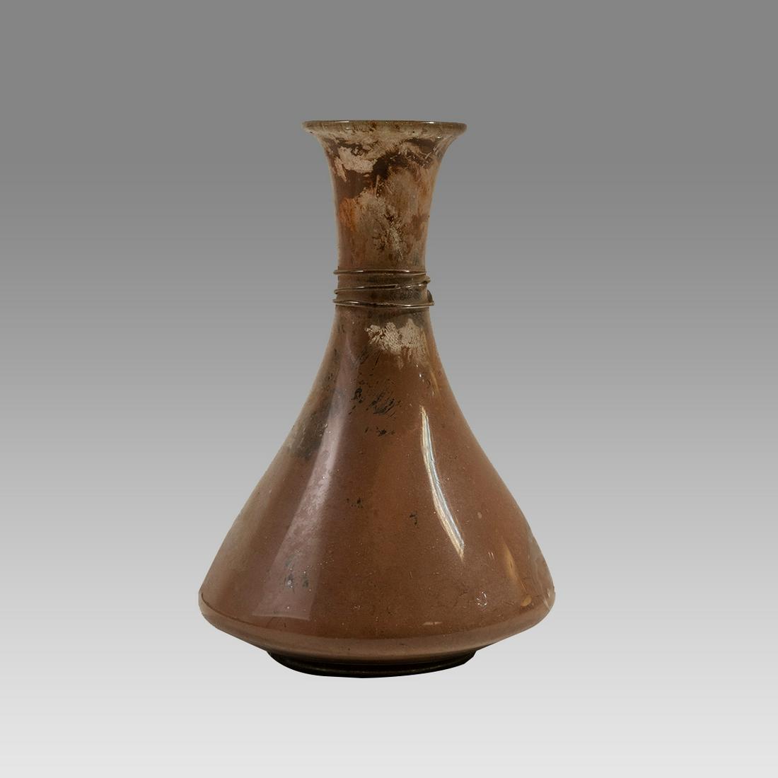 Ancient Roman Large Glass Bottle c.1st-4th Century A.D.: Ancient Roman Large Glass Bottle c.1st-4th Century A.D. Size 5 3/4 inches high. Fine Roman Glass footed bottle with flared rim. Provenance: Property of David Straus.