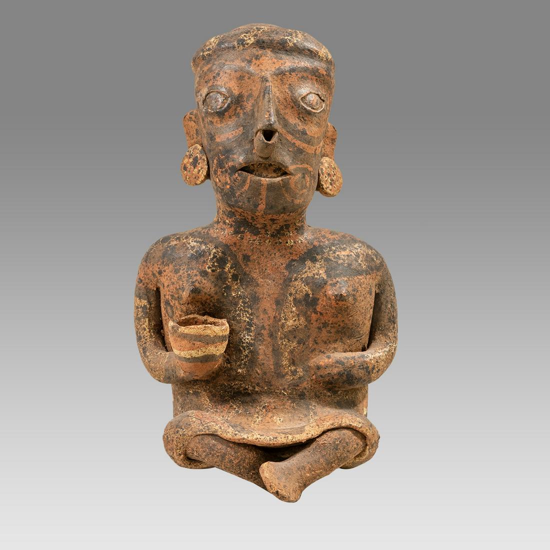 Ancient Pre Columbian Nayarit Female Figure western Mexico, c. 100 B.C. - 250 A.D.: Ancient Pre Columbian Nayarit Female Figure western Mexico, c. 100 B.C. - 250 A.D. Size 9 1/4 inches high. Fne pottery seated female figure holding a bowl in her right hand, with ear and nose ornament