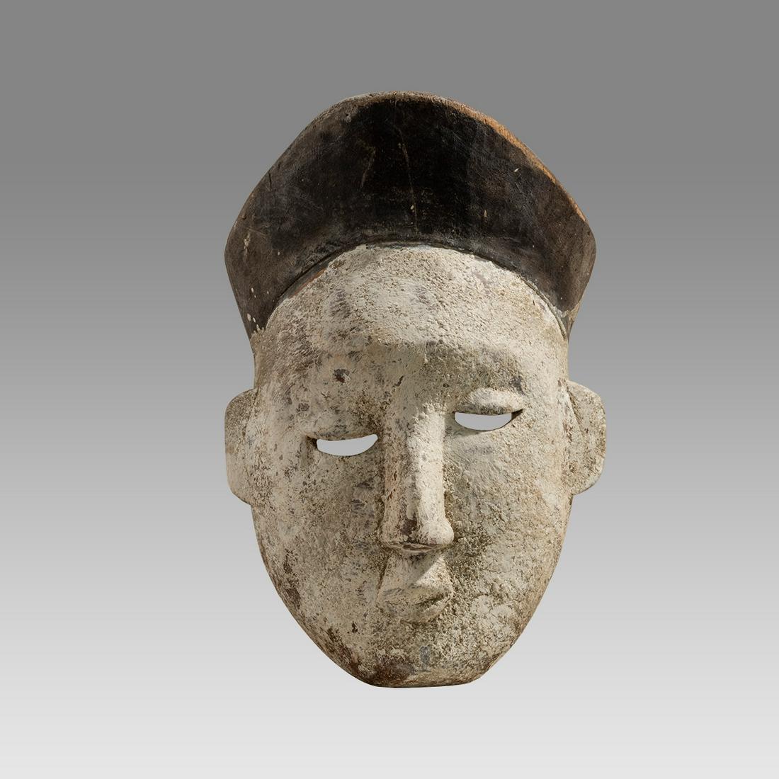 Africa, Nigeria Painted Wood Mask c.early 20th century.: Africa, Nigeria Painted Wood Mask c.early 20th century. Size 10 inches high. 7 1/2 inches wide. Fne carved painted wooden mask with open work eyes, black painted headdress. Provenance: EX: Seymour col