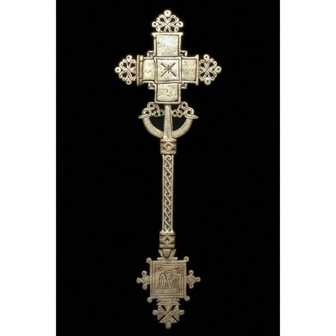Ethiopian Coptic Processional Cross Ca. 20th century.: Ethiopian Coptic Processional Cross Ca. 20th century. Size 14 inches high, 4 1/4 inches wide. A cast Low grade silver processional cross having openwirk and guilloche designs. Small relic door opens t