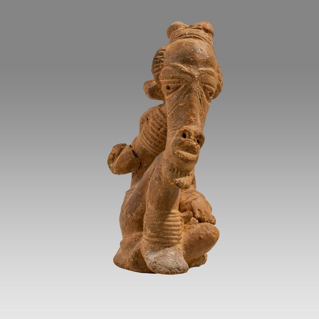 Nok figure-Terracotta of a man. NOK, NIGERIA, II CENTURY BC - II CENTURY AC.: Nok figure-Terracotta of a man. NOK, NIGERIA, II CENTURY BC - II CENTURY AC. Size 9 inches high. A seated terracotta figure of a bearded man, wearing headdress. Ex Private New York city collection acq