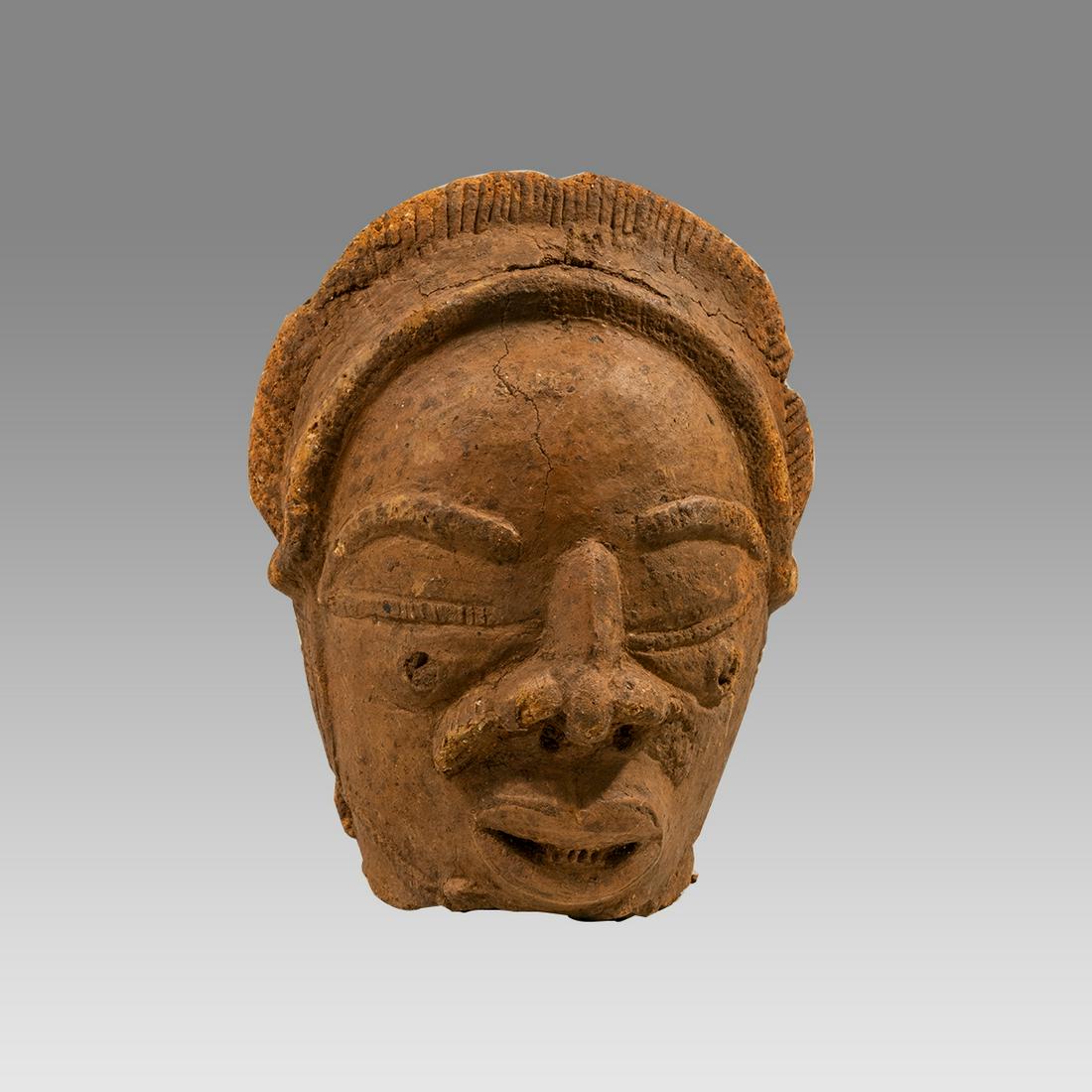 Nok Terracotta Head of a man. NIGERIA, II CENTURY BC - II CENTURY AC.: Nok Terracotta Head of a man. NIGERIA, II CENTURY BC - II CENTURY AC. Size 7 1/2 inches high. A lifesize terracotta head of a man, wearing headdress. Ex Private New York city collection acquired 1980'