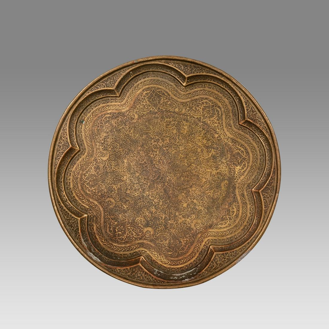 A Middle Eastern Syrian Copper Tray.: A Middle Eastern Syrian Copper Tray. Size 14 7/8 inches diameter. 19th century Syrian copper tray, decorated with fine engraved floral design.