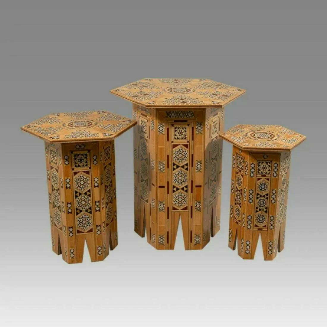 A Set Of Three SYRIAN Moorish octagonal Wood Tables with Inlay geometric design.: A Set Of Three SYRIAN Moorish octagonal Wood Tables with Inlay geometric design.size Largest 19 3/4 inches high x 16 1/4 inches wide. Medium 16 3/4 inches high x 13 inches wide. Small table 15 inches 