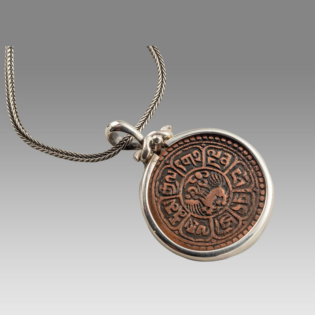 Tibetan Bronze coin set in Silver Necklace 19th Century.: Tibetan Bronze coin set in Silver Necklace 19th Century. Fine condition. The coin is authentic set in Modern Silver necklace. wearable. Size 16 3/4 inches length + extension, bezel 25 mm wide.
