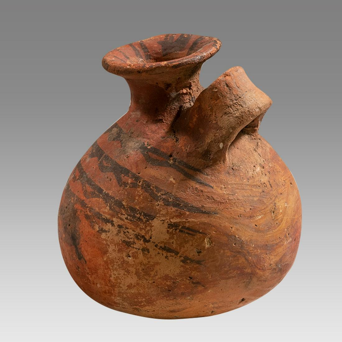 Ancient Egypt, Predynastic Period, Nagada II, ca. 3200 BC â€“ 3000 BC.: Ancient Egypt, Predynastic Period, Nagada II, ca. 3200 BC â€“ 3000 BC. A round vessel decorated with zig zag designs in a brown-black pigment over a red base. A wide flared spout with shallow nec