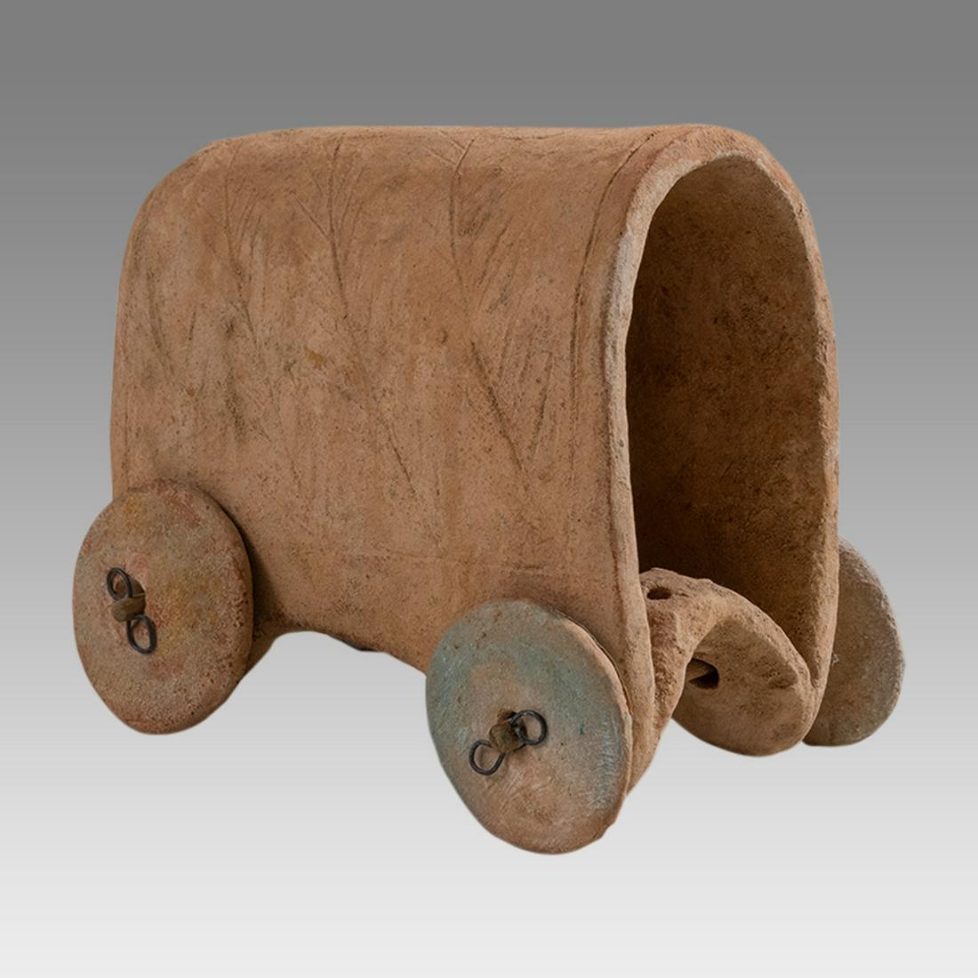 Sumerian Style Terracotta Chariot with Wheels.: Sumerian Style Terracotta Chariot with Wheels. Size 5 x 4 1/2 inches. A hollow terracotta wagon or chariot with four wheels. The body decorated with etched tree design. Not Ancient. Provenance: Ex Fra