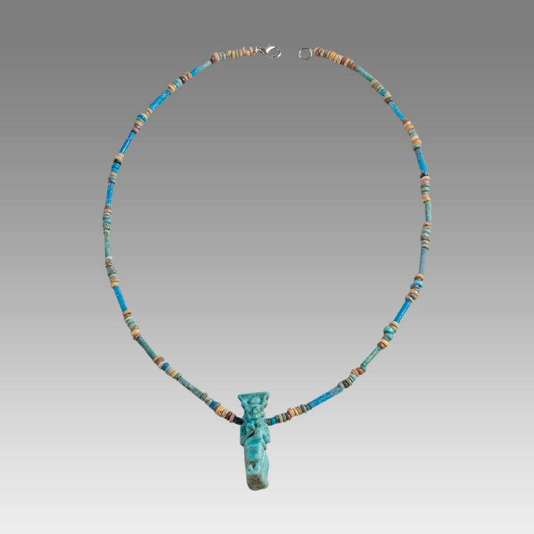 Ancient Egyptian Faience Bead Necklace c.300-50 BC.: Ancient Egyptian Faience Bead Necklace c.300-50 BC. Size 18 1/4 inches length. Great Looking single strand Faience Bead necklace with large blue faience Isis and child Horus amulet. wearable. Provenan