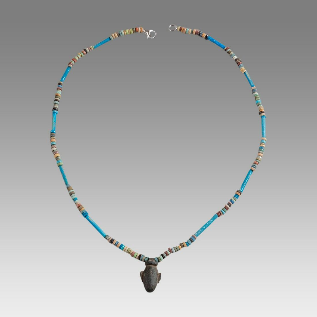 Ancient Egyptian Faience Bead Necklace c.300-50 BC.: Ancient Egyptian Faience Bead Necklace c.300-50 BC. Size 18 3/4 inches length. Great Looking single strand Faience Bead necklace with stone heart Amulet, late period 300-50 BC. wearable. Provenance: E