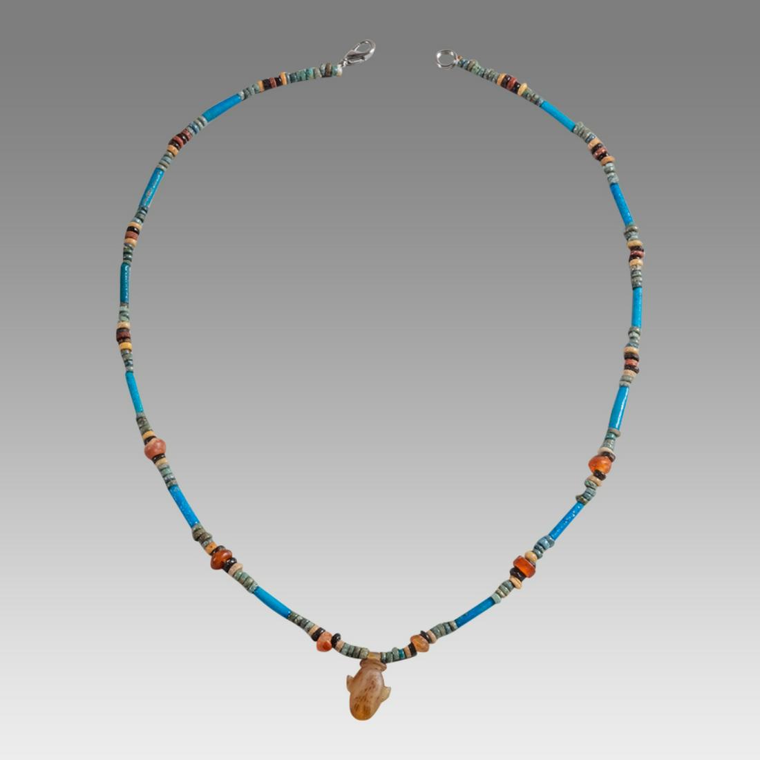 Ancient Egyptian Faience Bead Necklace c.300-50 BC.: Ancient Egyptian Faience Bead Necklace c.300-50 BC. Size 18 inches length. Great Looking single strand Faience Bead necklace. with stone heart amulet. wearable. Provenance: Ex Secret Eyes Gallery New 