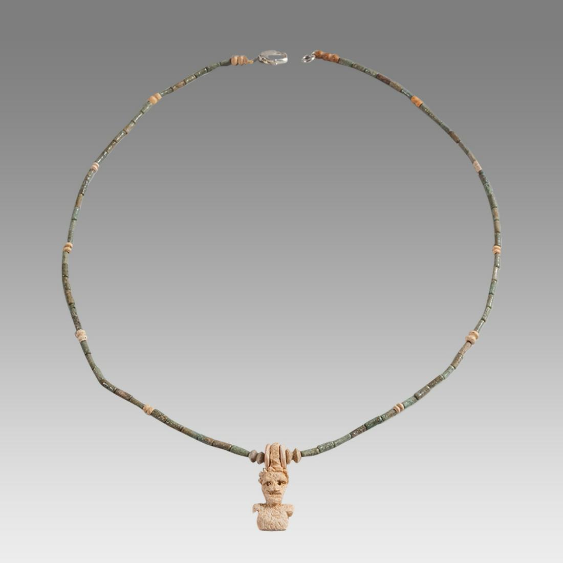 Ancient Egyptian Faience Bead Necklace c.300-50 BC.: Ancient Egyptian Faience Bead Necklace c.300-50 BC. Size 19 3/4 inches length. Great Looking single strand Faience Bead necklace. with carved bone bust of a man amulet. wearable. Provenance: Ex Secret