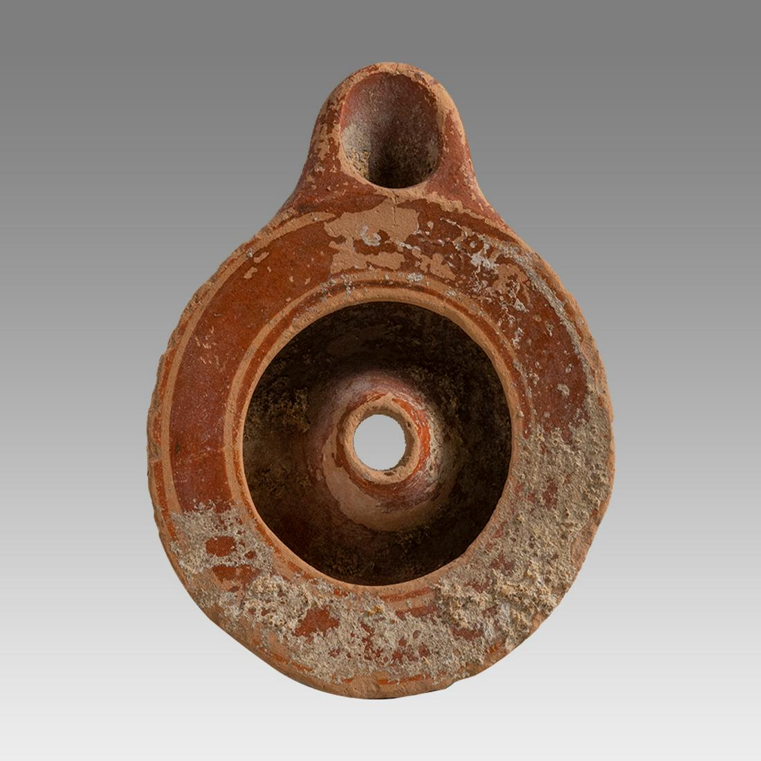 Ancient Greek South Italian Terracotta Oil Lamp c.4th century BC.: Ancient Greek South Italian Terracotta Oil Lamp c.4th century BC. Size 4 1/2 inches length x 3 1/2 inches wide. Ancient Greek South Italian Terracotta oil lamp red paint. Rare. Provenance: Collection 