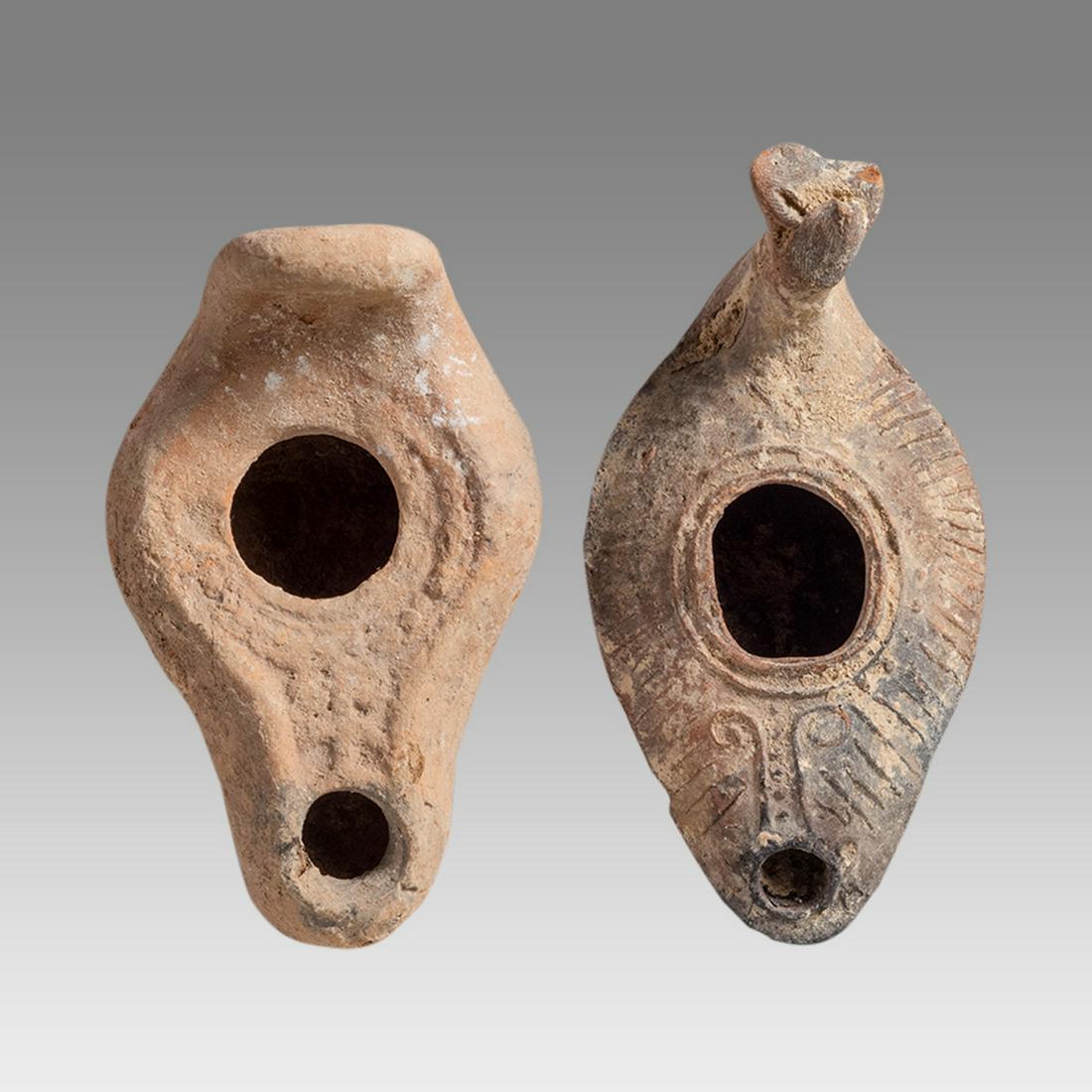 Lot of 2 Ancient Holy Land Byzantine Terracotta Oil Lamps c.5th AD.: Lot of 2 Ancient Holy Land Byzantine Terracotta Oil Lamps c.5th AD. Size 4 inches length x 2 3/8 inches wide. Ancient Holy land Byzantine period Terracotta oil lamp decorated with a Cross and ornate d