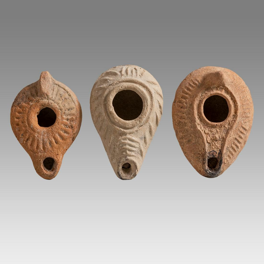 Lot of 3 Ancient Holy Land Byzantine Terracotta Oil Lamps c.5th AD.: ot of 3 Ancient Holy Land Byzantine Terracotta Oil Lamps c.5th AD. Size 3 3/4 - 4 inches length x 2 1/2 - 3 inches wide. Ancient Holy land Byzantine period Terracotta oil lamps decorated with ornate d