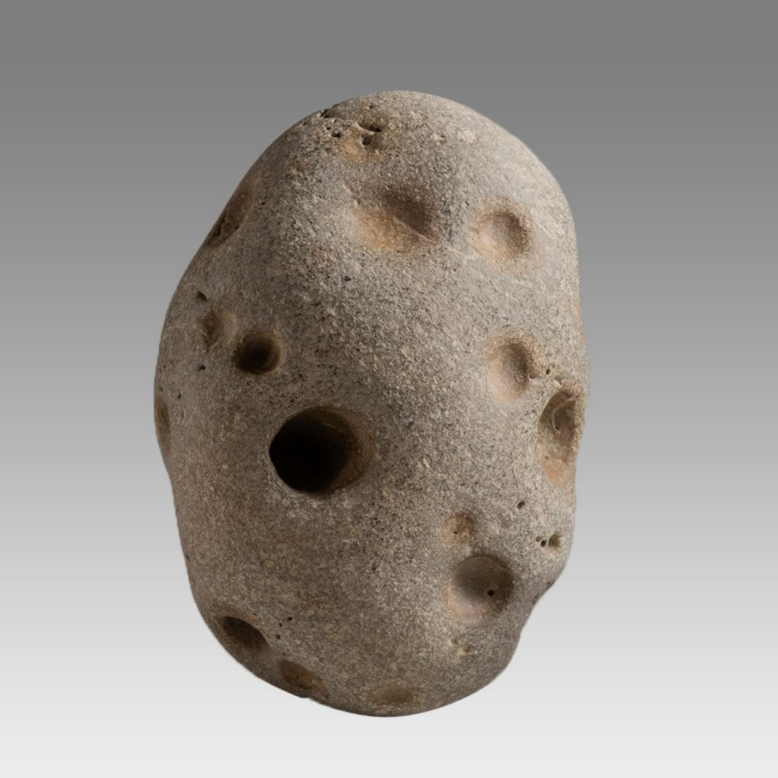 Ancient Holy Land Roman Stone Base for Fire Starter c.1st century AD.: Ancient Holy Land Roman Stone Base for Fire Starter c.1st century AD. Size 4 3/4 inches length x 2 3/4 inches wide. Rare Stone base with holes, used for fire starter, one of the holes with traces of w