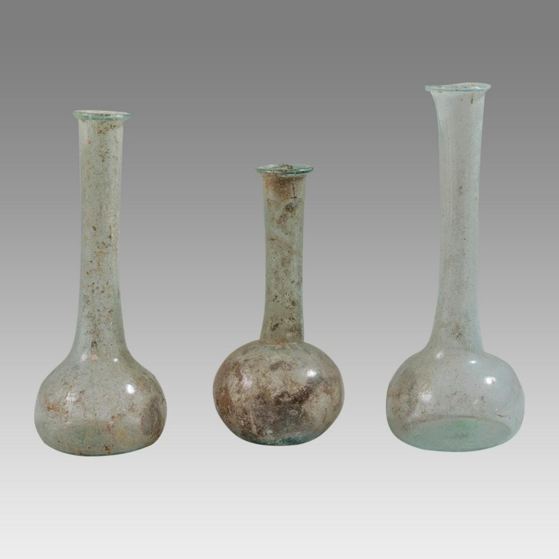 Lot of 3 Ancient Holy Land Roman Glass Bottles c.2nd century AD.: Lot of 3 Ancient Holy Land Roman Glass Bottles c.2nd century AD. Size 3 3/4 - 4 3/4 inches high. A collection of 3 Roman Glass Bottles. Provenance: Private NYC collection acquired in The New York Mark
