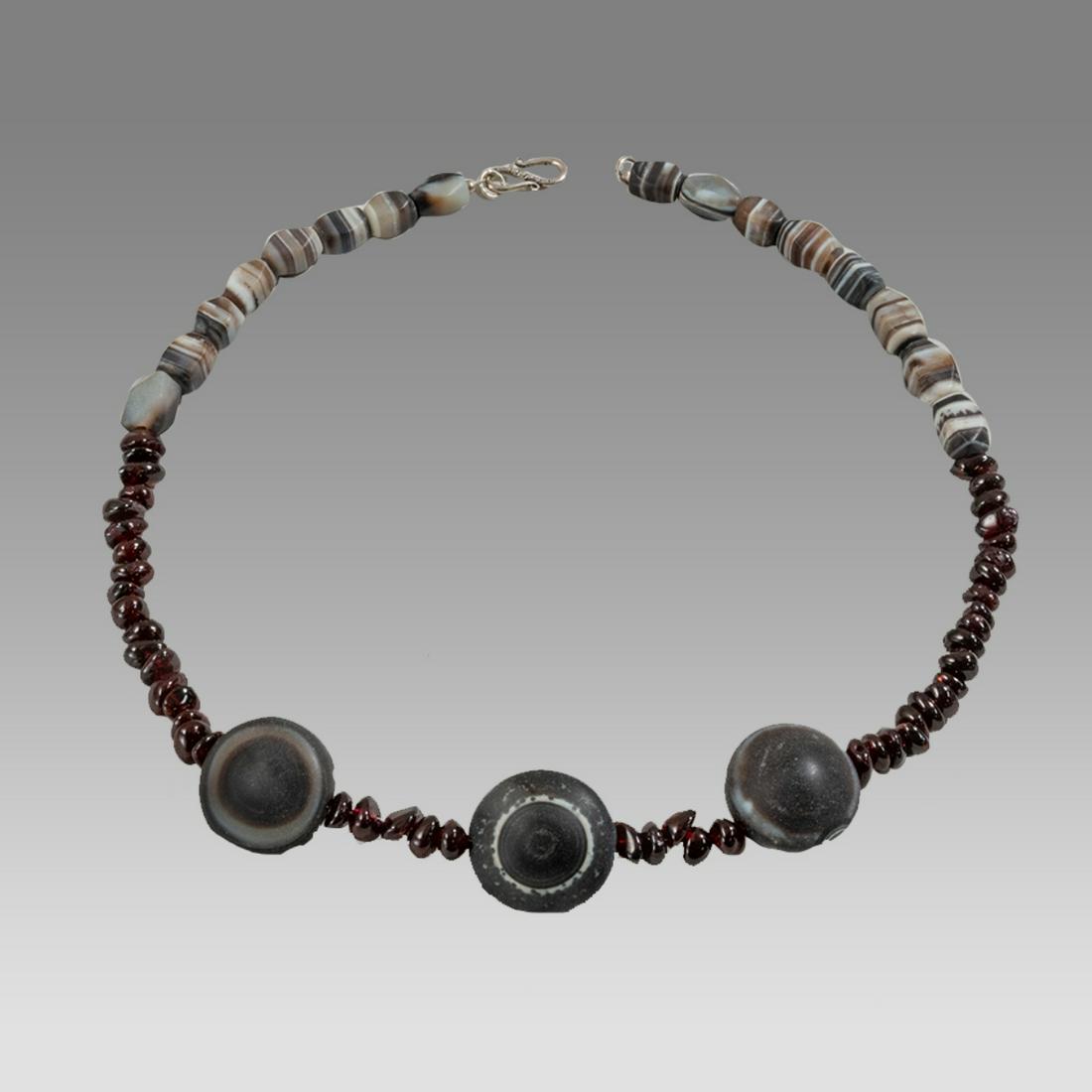 Near Eastern Banded Agate, Garnet Bead Necklace.: Near Eastern Banded Agate, Garnet Bead Necklace. Size 19 1/2 inches length. Size of beads 8-24 mm. Fine single strand large banded agate beads, with red Garnet beads. wearable. Provenance: Ex Pegasi N