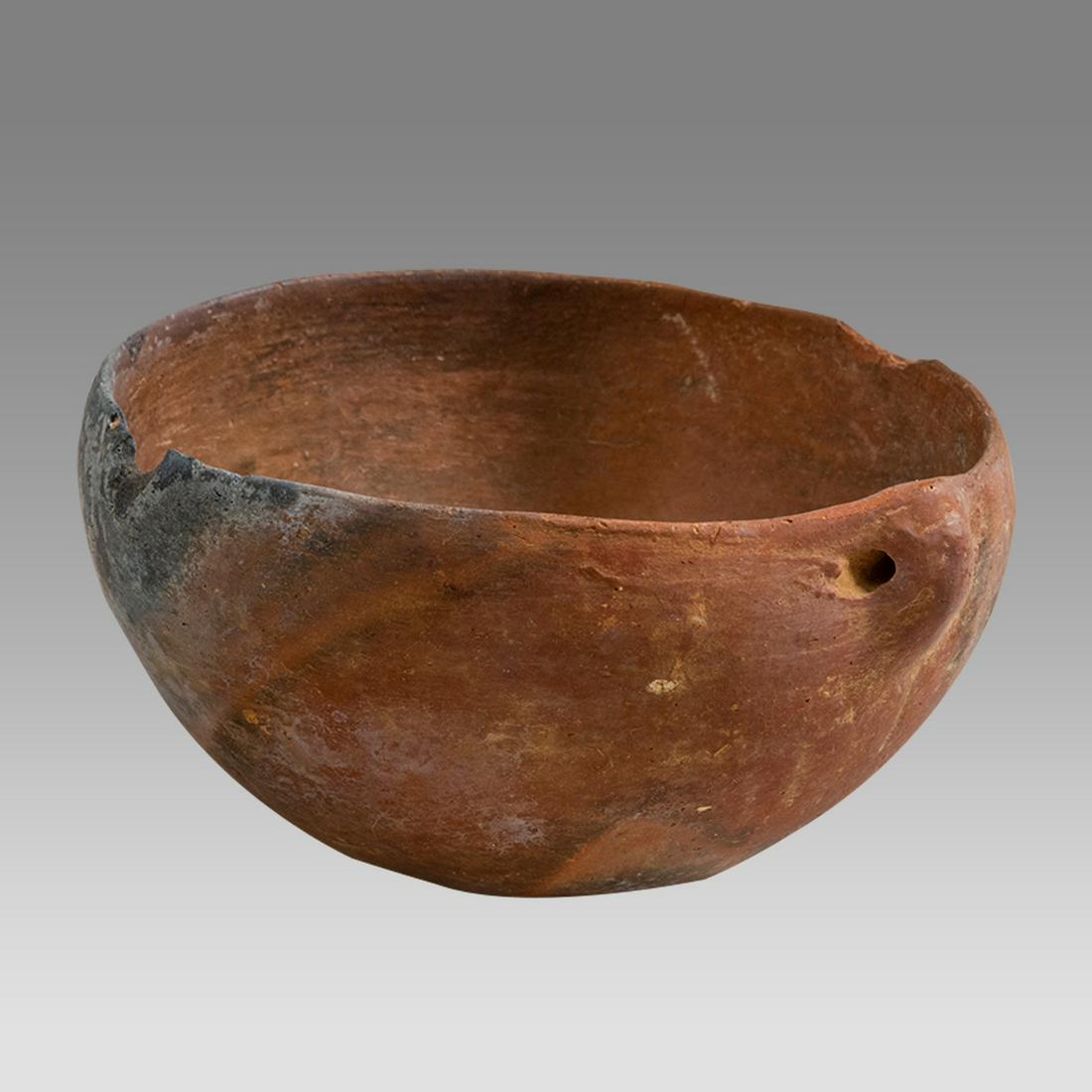 Ancient Cypriot Terracotta Bowl c.1000 century BC.: Ancient Cypriot Terracotta Bowl c.1000 century BC. Size 4 1/4 inches diameter. 2 inches high. A red terracotta bowl with suspension handle. Provenance: Private NYC Collection acquired from Frishman Ga