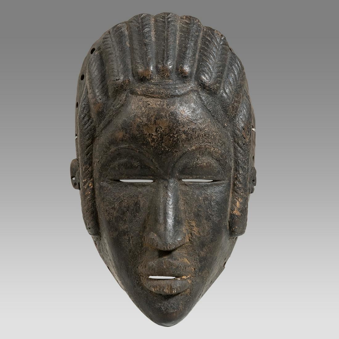 African Ivory Coast Wooden Mask.: African Ivory Coast Wooden Mask. Size 9 7/8 inches high x 5 3/4 inches. Carved wooden mask Ivory coast Balsa. of a woman with breaded hair. pierced at the edge. Private New York City Collection 1980's