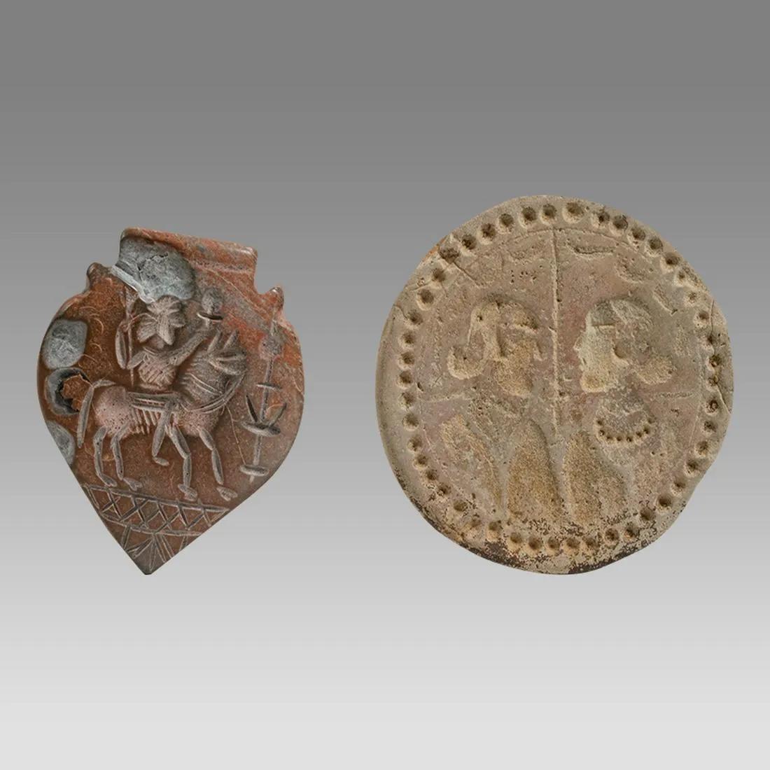 Lot of 2 Near Eastern Stone Seals.: Lot of 2 Near Eastern Stone Seals. Size 42 - 38 mm. Unusual form of 2 seals carved with animals and a king on a horse. Age unknown. Provenance: Private NYC Collection acquired from the London Market a