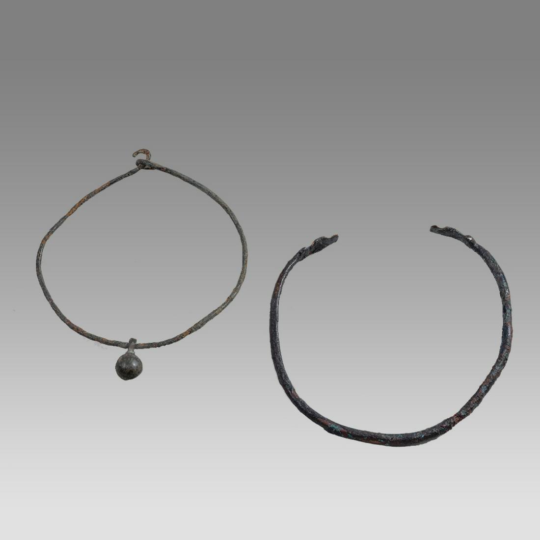 Lot of 2 Ancient Roman Bronze Bracalets c.1st-2nd century AD.: Lot of 2 Ancient Roman Bronze Bracalets c.1st-2nd century AD. Size 2 3/8 - 2 5/8 inches length. A collection of 2 Roman bronze bracalets one with snake heads. Provenance: Collection of David Van Vleck