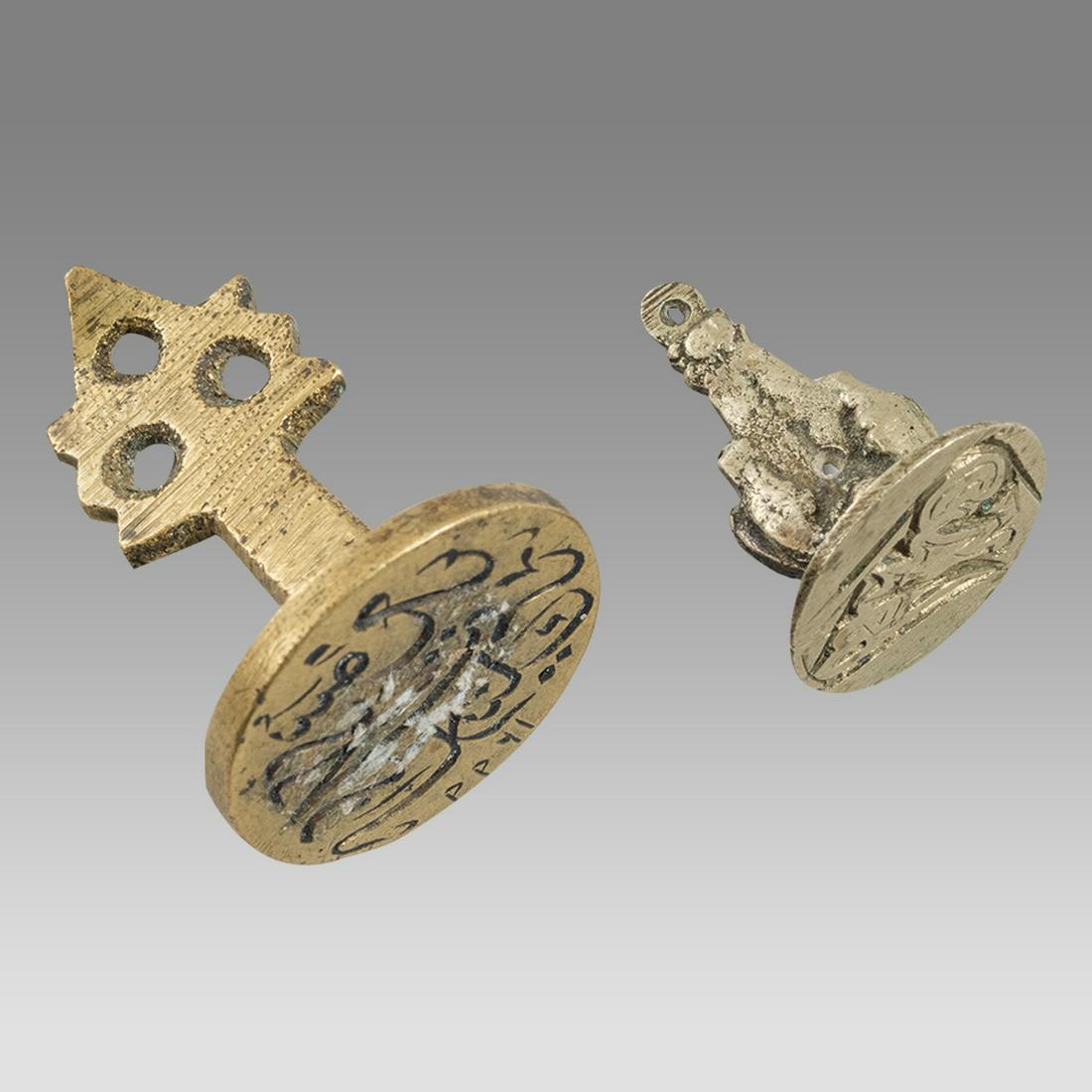 Lot of 2 Islamic Bronze Seals with Arabic 19th century.: Lot of 2 Islamic Bronze Seals with Arabic 19th century. Size 0 3/4 - 1 3/8 inches length. Cast bronze Islamic seals with suspension handle. Provenance: From a NYC collection acquired in the 1970s