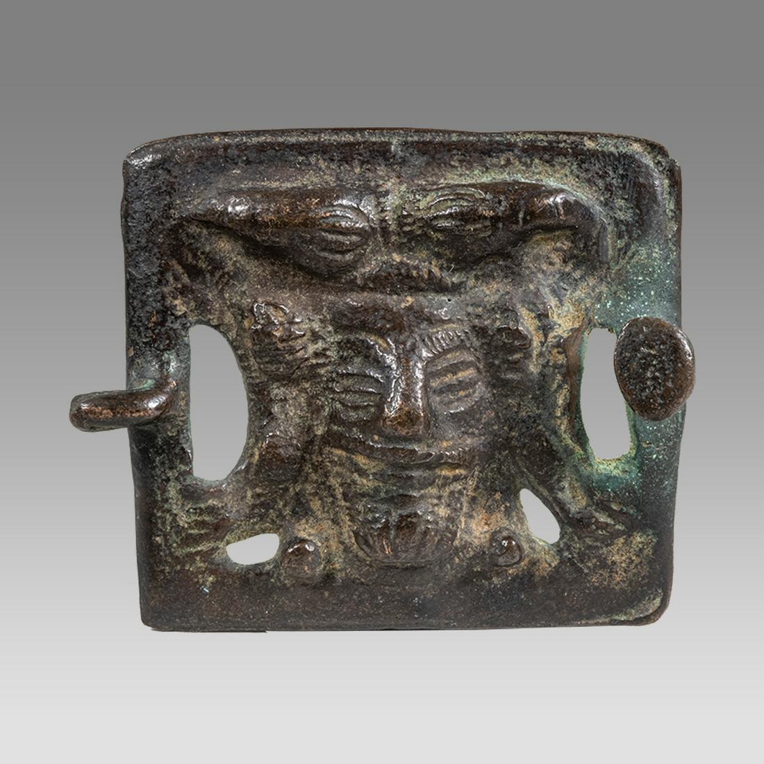 Ancient Luristan Bronze Ornament c.1000 BC.: Ancient Luristan Bronze Ornament c.1000 BC. Size 2 1/2 x 2 1/4 inches. Unusual Luristan cast bronze ornament (buckle) with bearde man with hors. Provenance: From a NYC collection acquired in the 1970s