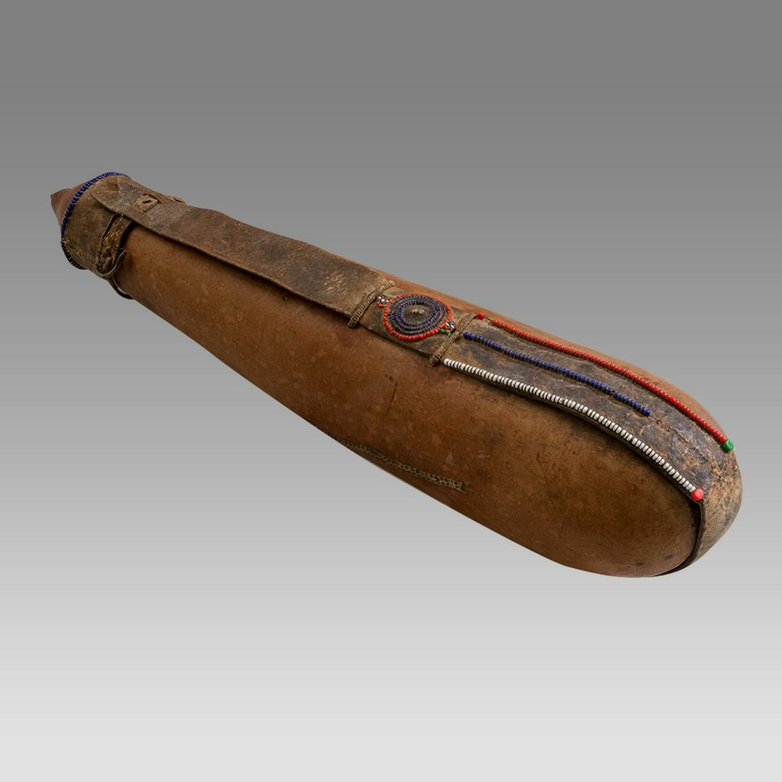 African gourd jug, with leather straps with beaded accents. (1 of 2)