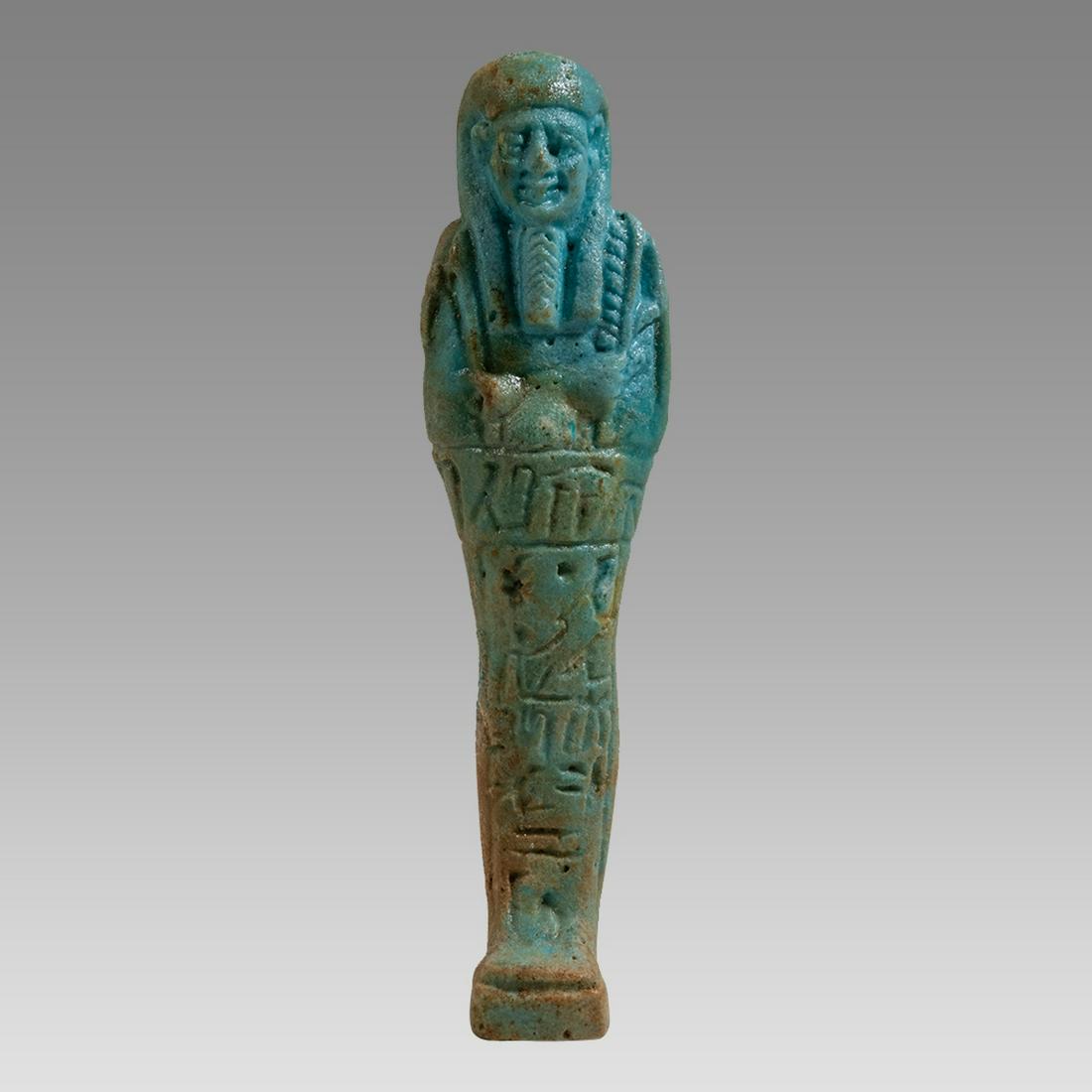 Ancient Egyptian Blue Faience Ushabti c.26th Dynasty, ca 672 to 525 BC.: Ancient Egyptian Blue Faience Ushabti c.26th Dynasty, ca 672 to 525 BC. Size 4 1/4 inches high. Fine blue/green glazed faience Ushabti figure standing mummiform ushabti, depicted wearing the royal wig