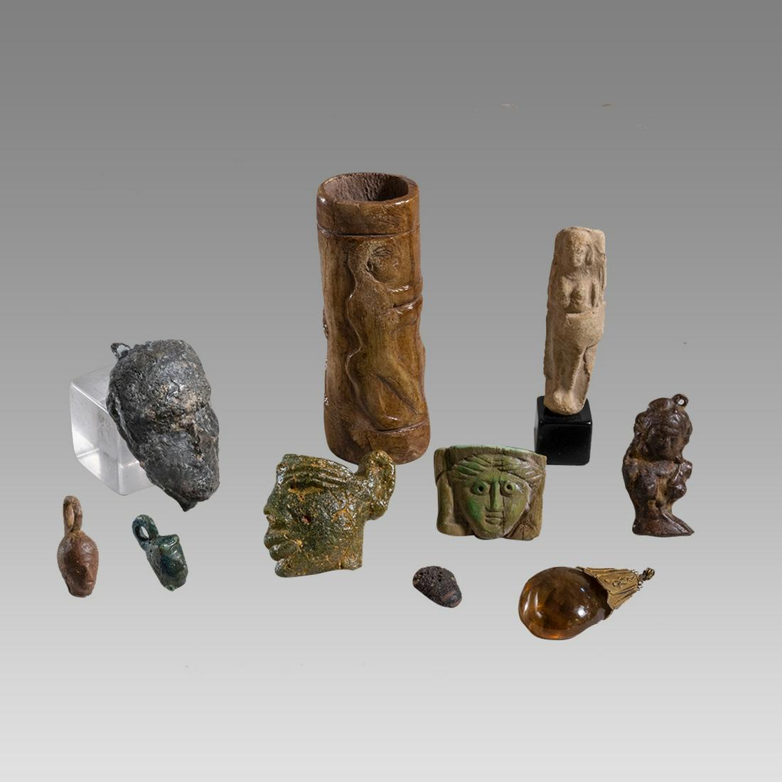 Lot of 10 Ancient Egyptian, Roman Misc Lot c.1st cent BC. 4th century AD.: Lot of 10 Ancient Egyptian, Roman Misc Lot c.1st cent BC. 4th century AD. Size 1 - 3 3/4 inches length. A collection of 10 cast bronze amulets, Bone fragments, Glass face profile a Phoenician Terracot