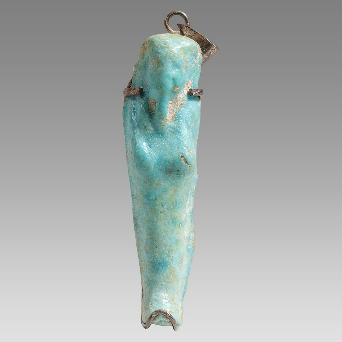 Ancient Egyptian Blue Faience Ushabti Late Period ca 300-50 BC.: Ancient Egyptian Blue Faience Ushabti Late Period ca 300-50 BC. Size 2 3/84 inches high. A blue glazed faience Ushabti figure standing mummiform ushabti, depicted wearing the royal wig and beard, hold