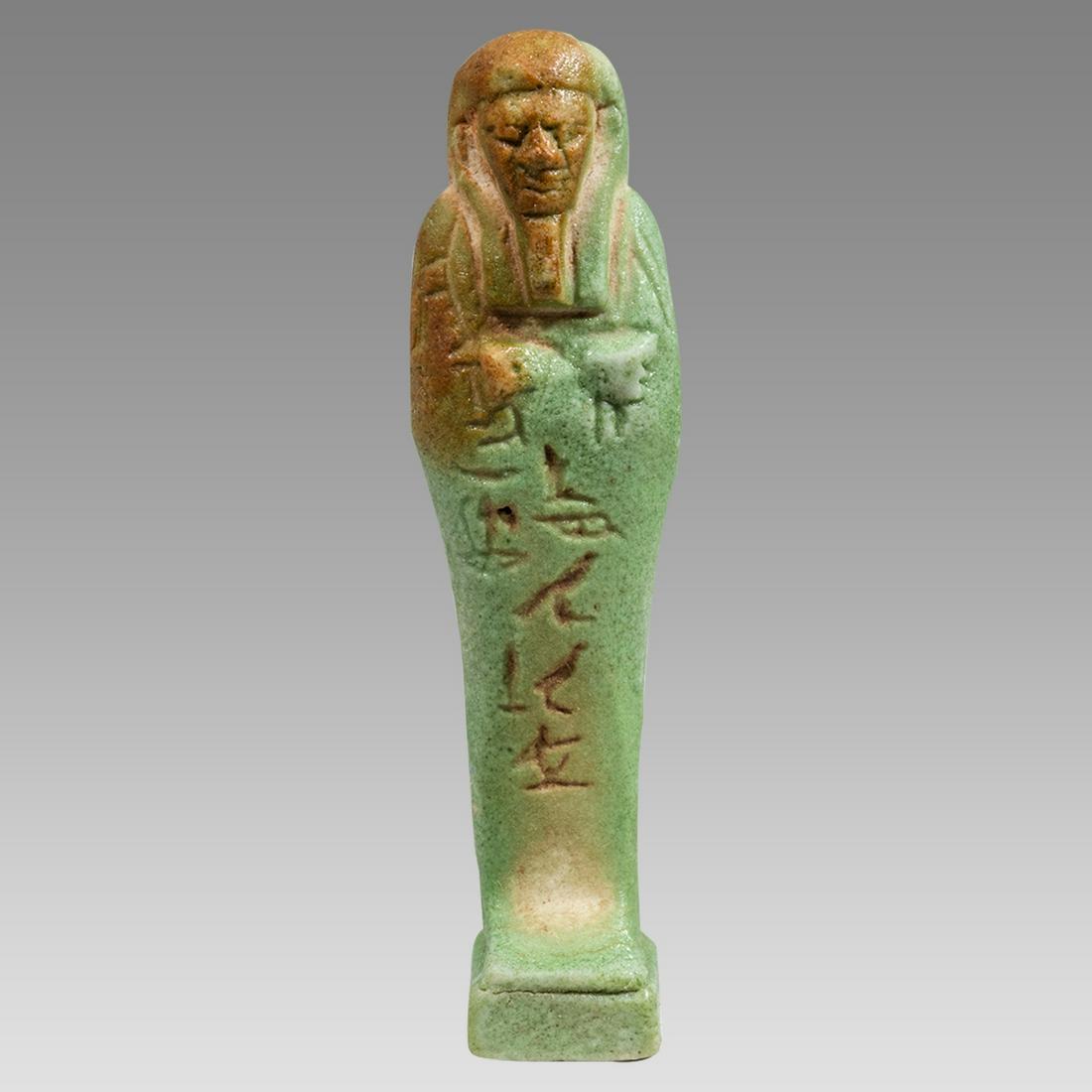 Ancient Egyptian Green Faience Ushabti c.26th Dynasty, ca 672 to 525 BC.: Ancient Egyptian Green Faience Ushabti c.26th Dynasty, ca 672 to 525 BC. Size 3 3/4 inches high. Fine green glazed faience Ushabti figure standing mummiform ushabti, depicted wearing the royal wig and