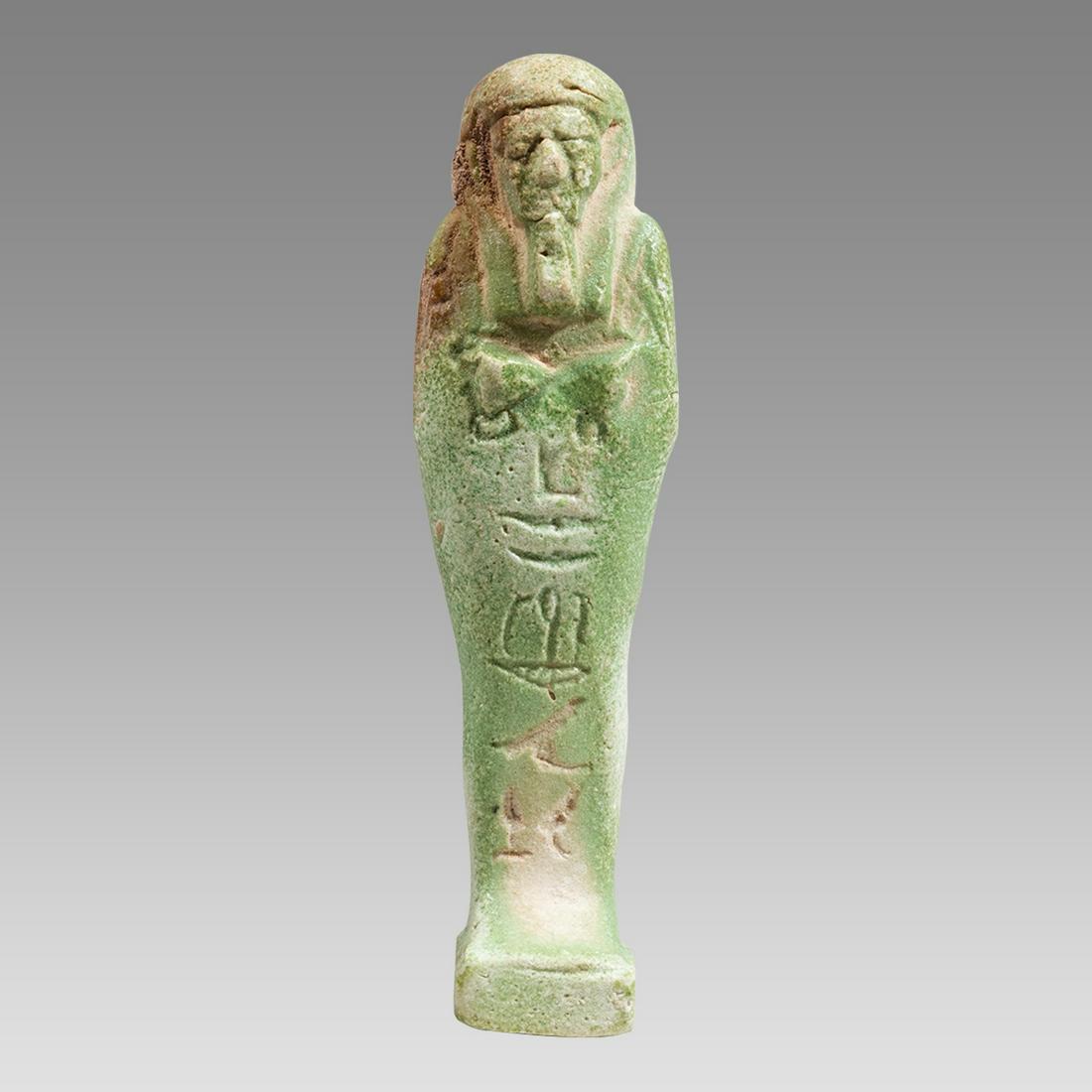 Ancient Egyptian Green Faience Ushabti c.26th Dynasty, ca 672 to 525 BC.: Ancient Egyptian Green Faience Ushabti c.26th Dynasty, ca 672 to 525 BC. Size 3 3/4 inches high. Fine green glazed faience Ushabti figure standing mummiform ushabti, depicted wearing the royal wig and