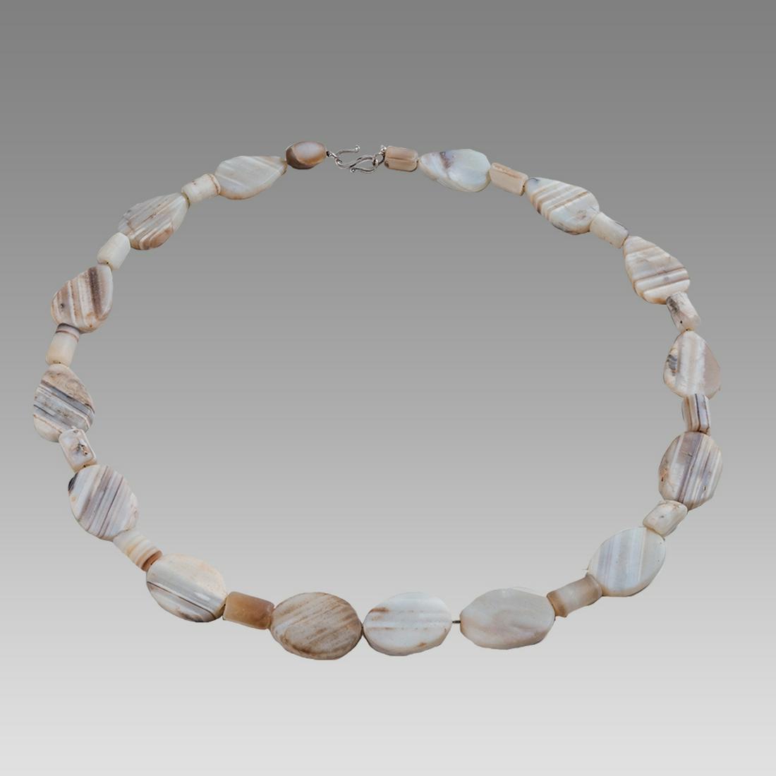 Near Eastern Banded Agate Bead Necklace.: Near Eastern Banded Agate Bead Necklace. Size 26 1/2 inches length. Size of beads 0 3/8- 1 1/4 inch length. Fine single strand large banded agate beads. wearable. Provenance: Ex Pegasi Numismatics MI