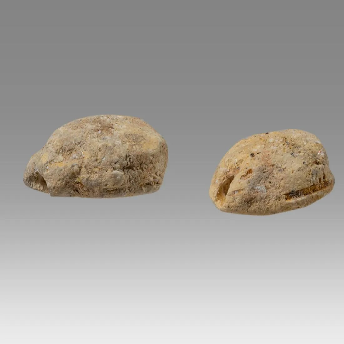 Lot of 2 Ancient Egyptian Faience Scarabs c.600 BCE.: Lot of 2 Ancient Egyptian Faience Scarabs c.600 BCE. Size 12-13 mm. Lot of 2 small Faience scarabs Late period, with stealized beatle back. Provenance: Ex Secret Eyes Gallery New York 1970's-1980's.