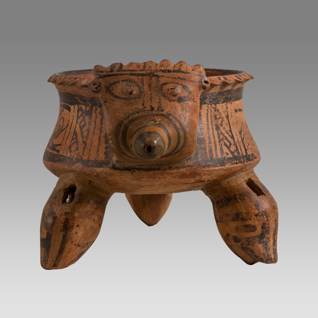 Ancient Pre-Columbian, Costa Rican Pottery Tripod Bowl c.500 to 700 AD.: Ancient Pre-Columbian, Costa Rican Pottery Tripod Bowl c.500 to 700 AD. Size 5 inches high. 7 inches wide. A Costa Rican pottery tripod bowl with rattle legs, handle with face. decorated with ornate d
