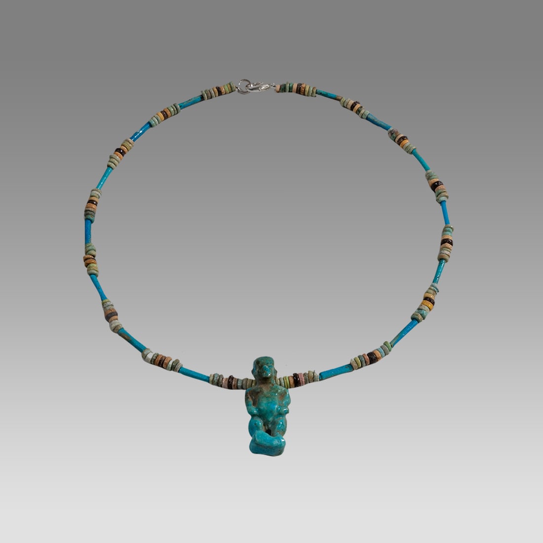 Ancient Egyptian Faience, Bead Necklace with Amulet c.300-50 BC.: Ancient Egyptian Faience, Bead Necklace with Amulet c.300-50 BC. Size 17 1/2 inches length. Great Looking single strand Faience Bead necklace with fine blue faience Pataikos amulet. wearable. Provenan