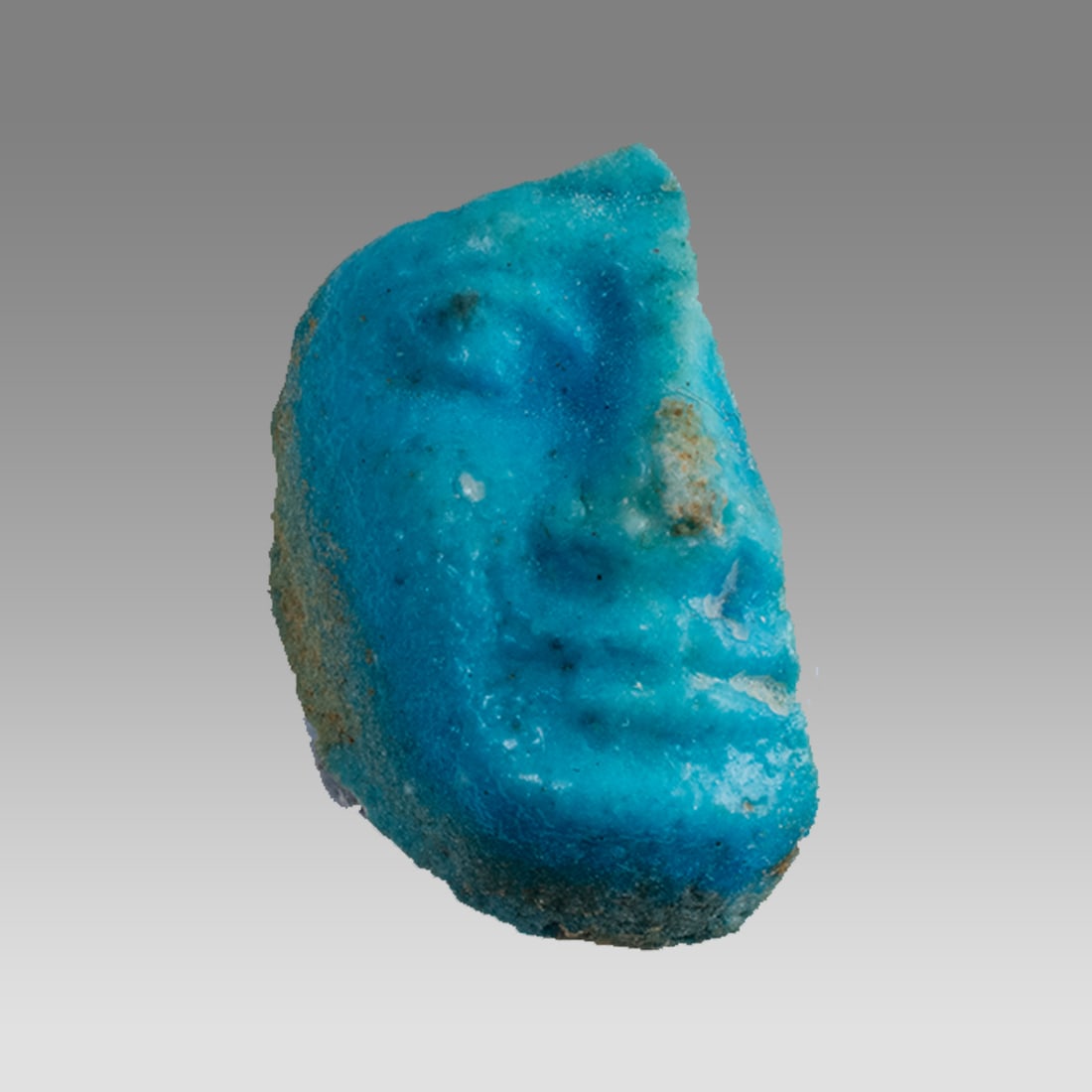Ancient Egyptian Human head fragment, Possibly of Patek/Pataikos, Medium Blue Faience, New Kingdom. (1 of 1)