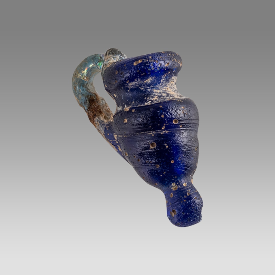 Ancient Roman, Byzantine Miniature Glass Jug c.4th-5th century AD.: Ancient Roman, Byzantine Miniature Glass Jug c.4th-5th century AD. Size 23 x 17 mm. Mini Oinochoe, Deep Blue Glass with Aqua Colored Handle, Roman-Byzantine 4th to start of 5th C CE, Reference: Louvre
