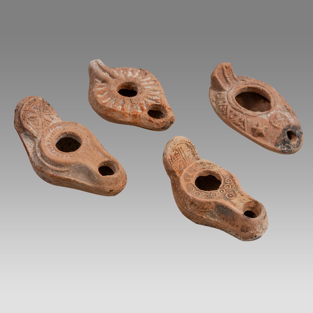 Ancient Holy Land Byzantine Terracotta Oil Lamps.: Ancient Holy Land Byzantine Terracotta Oil Lamps. Size 3 3/4 - 4 inches length. a. With Cross on Handle, b. With Cross on Handle, circles around center, 95x50mm, see Oil Lamps from Eretz Israel: The L