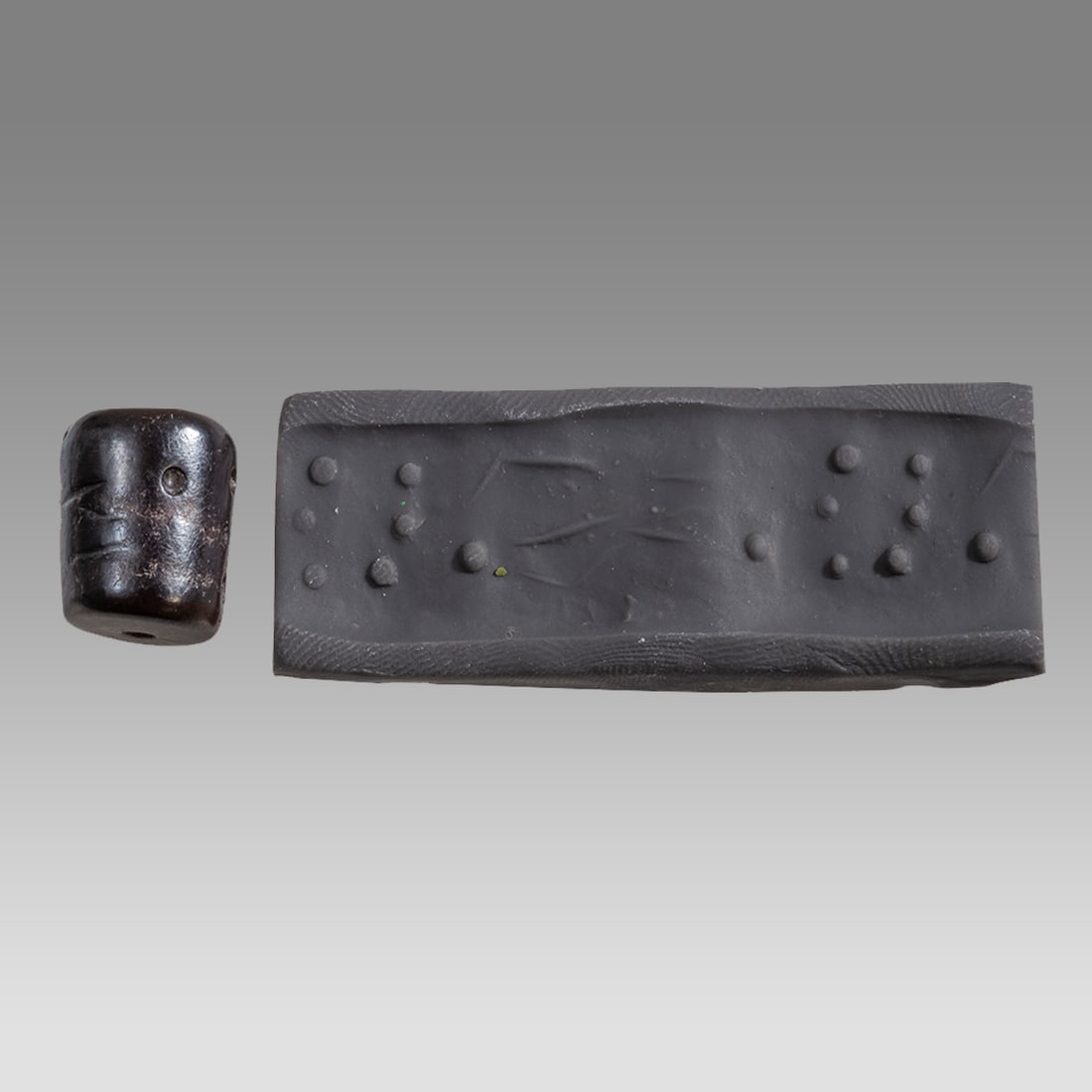 Near Eastern Heamatite Cylinder Seal.: Near Eastern Heamatite Cylinder Seal. Size 15 x 13 mm. Heamatite stone cylinder seal engraved with dotted design. Age unknown. Ex Fortuna Gallery NYC.