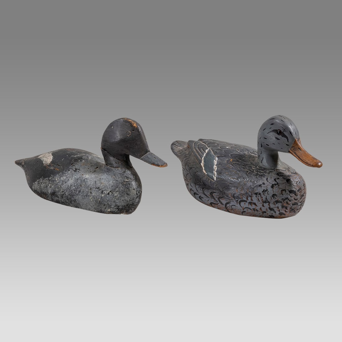 A pair of Antique Vintage Wood Ducks.: A pair of Antique Vintage Wood Ducks. Size 13 - 13 1/2 inches length. 6 1/4 inches high. One with marking at bottom Hand painted green winged Teak Female 1972.