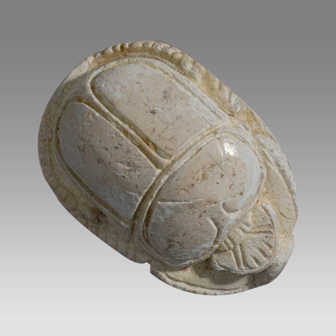 Ancient Egyptian Steatite Scarab New Kingdom c.1550-1070 BC.: Ancient Egyptian Steatite Scarab New Kingdom c.1550-1070 BC. Size 18 x 12 mm. A Steatite Scarab with stylized beetle back and bezel base engraved with coild cord pattern. Provenance: Private CA collec