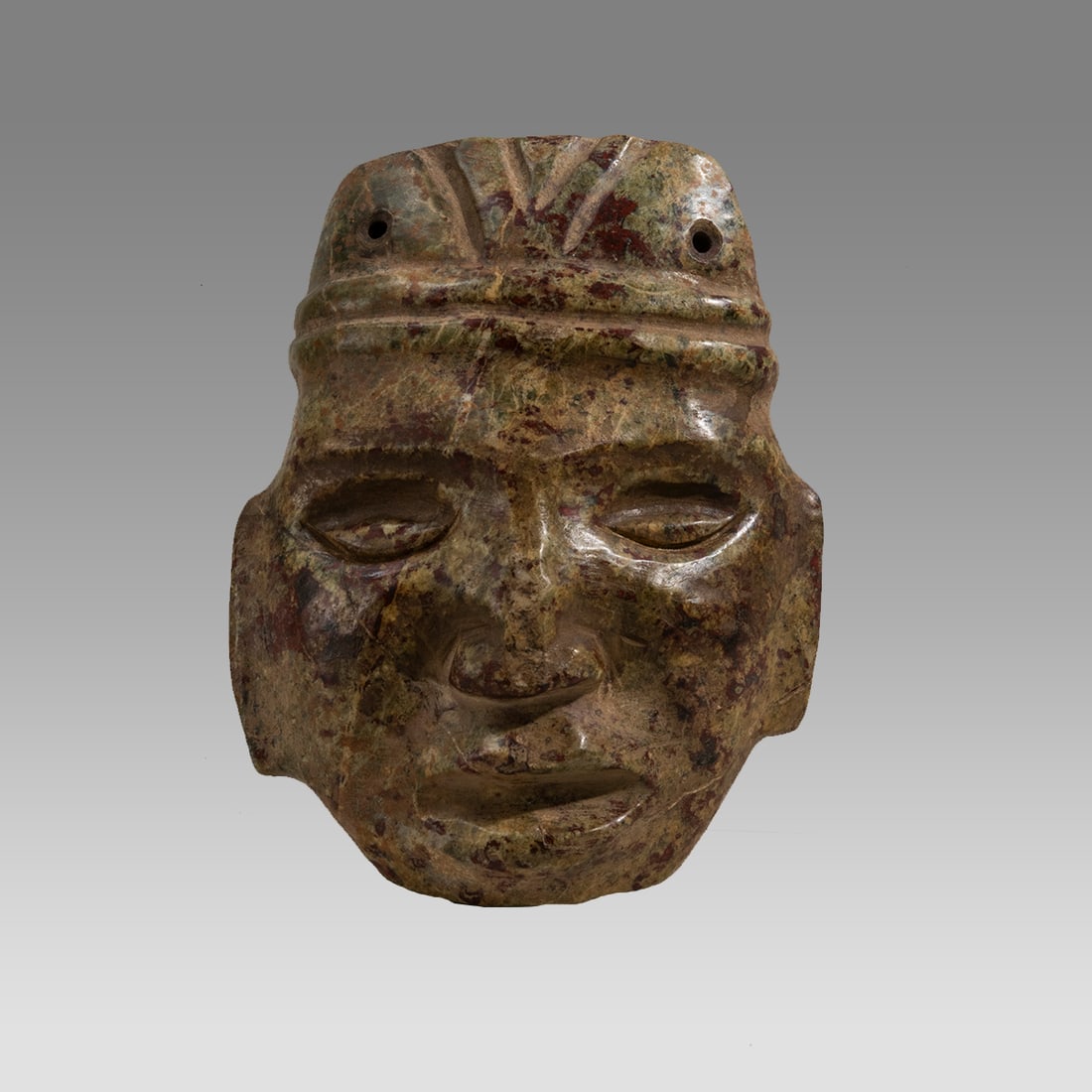 A colored jadeite hardstone Olmec mask. (1 of 3)