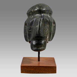 Guerrero Mezcala Stone Maskette, Mexico c.600-200 BC.: Guerrero Mezcala Stone Maskette, Mexico c.600-200 BC. Size 3 1/8 inches high + stand. Carved stone Maskette depicting a man with big nose and large ears, pierced fro suspension. Custom mounted. Proven